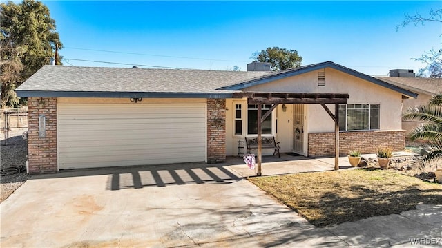 ranch-style house with an attached garage, brick siding, driveway, roof with shingles, and stucco siding