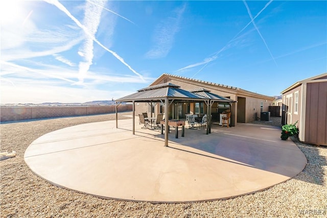 rear view of house featuring cooling unit, a patio, and a gazebo