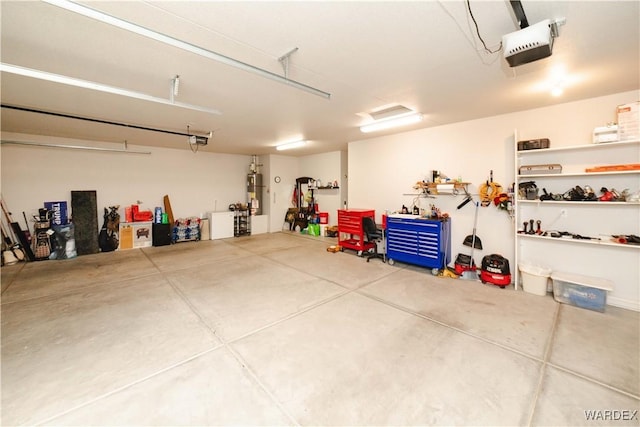 garage featuring gas water heater and a garage door opener