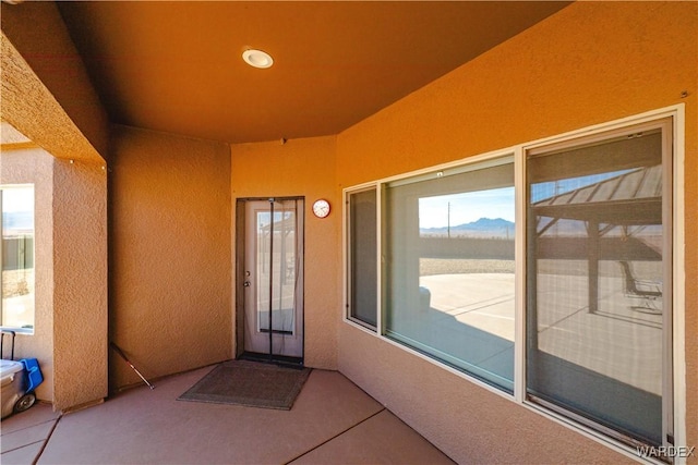 property entrance featuring stucco siding