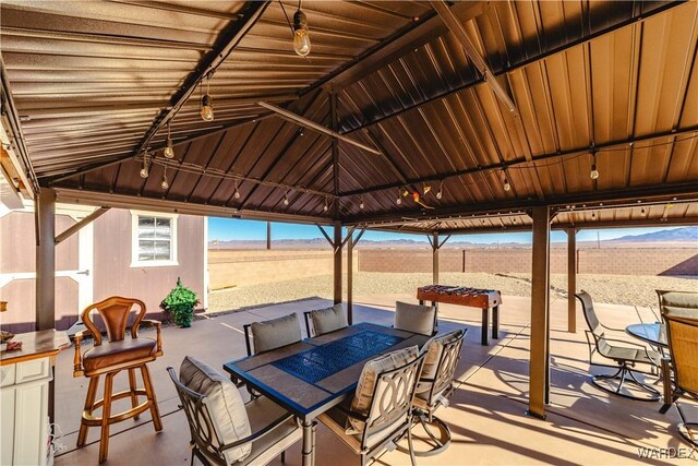 view of patio / terrace with a rural view, a fire pit, and a gazebo