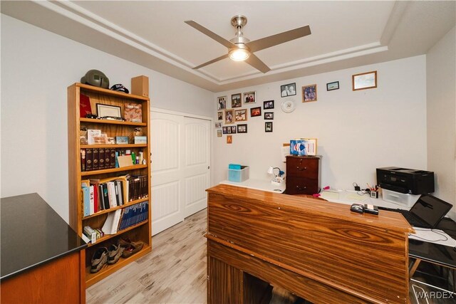 office featuring light wood-style floors and ceiling fan