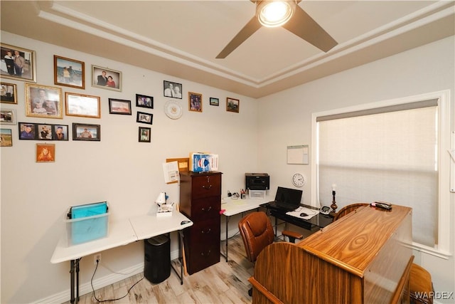 office space featuring baseboards, ceiling fan, and light wood finished floors