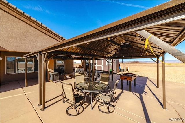 view of patio with a gazebo and outdoor dining space