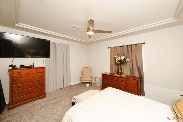 bedroom featuring a ceiling fan, visible vents, and light carpet