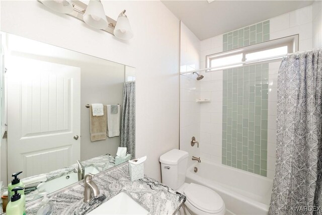 full bathroom featuring toilet, shower / bathtub combination with curtain, and vanity