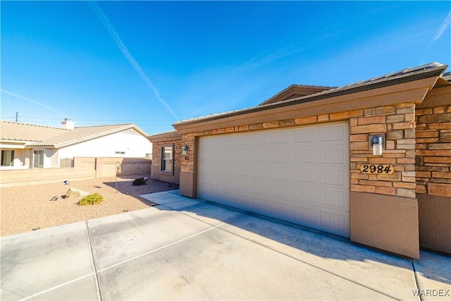 exterior space with concrete driveway and fence