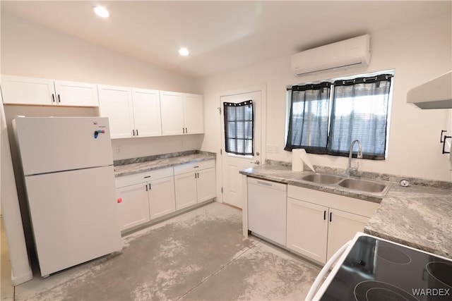 kitchen with an AC wall unit, white appliances, a sink, and white cabinetry