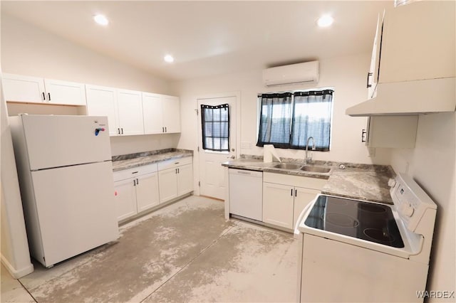 kitchen with white appliances, a wall mounted AC, a sink, and white cabinetry