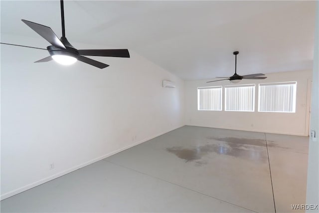 empty room featuring finished concrete flooring, vaulted ceiling, a ceiling fan, and baseboards