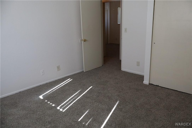 unfurnished bedroom with carpet floors and baseboards