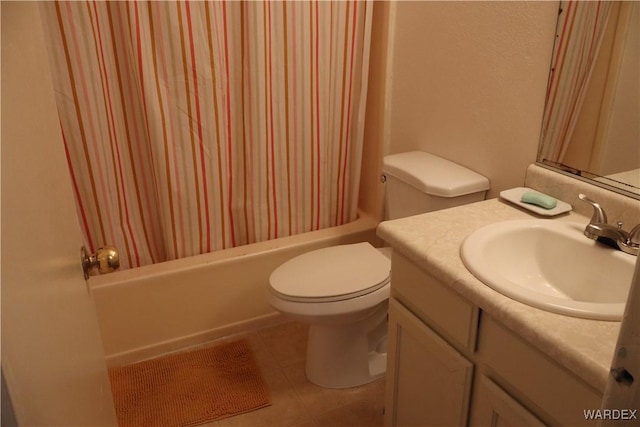 full bath featuring tile patterned flooring, shower / tub combo with curtain, vanity, and toilet