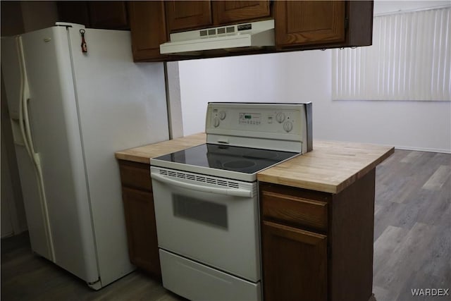 kitchen with dark brown cabinets, white appliances, wood finished floors, and under cabinet range hood