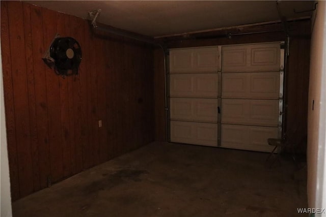 garage featuring wood walls