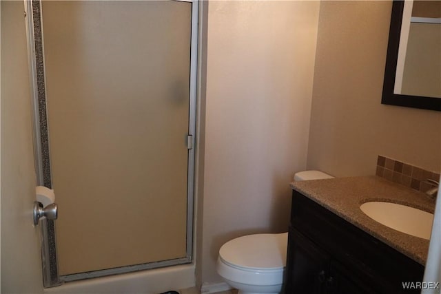 full bathroom with toilet, a shower stall, and vanity