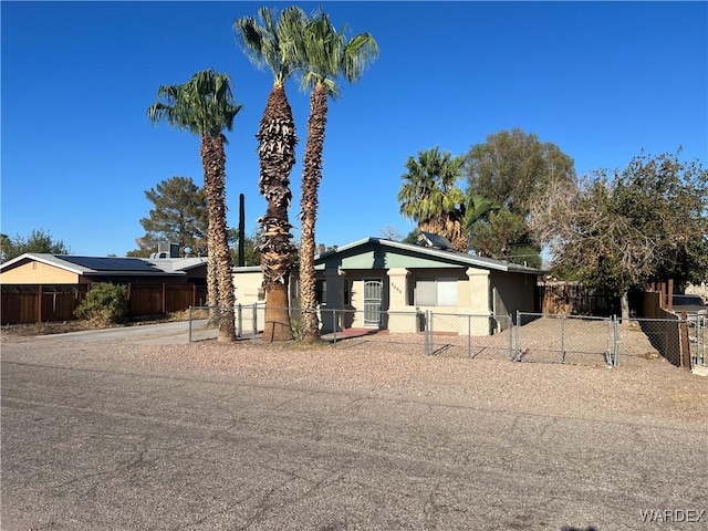 view of front of house with a fenced front yard and stucco siding