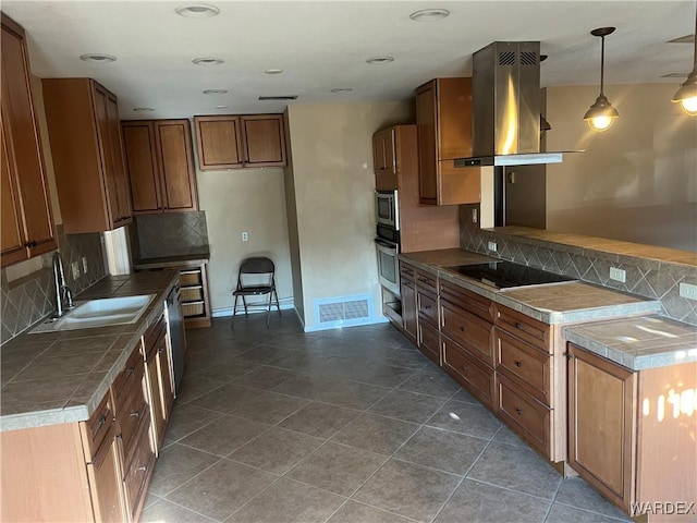 kitchen with stainless steel appliances, a sink, visible vents, island exhaust hood, and pendant lighting