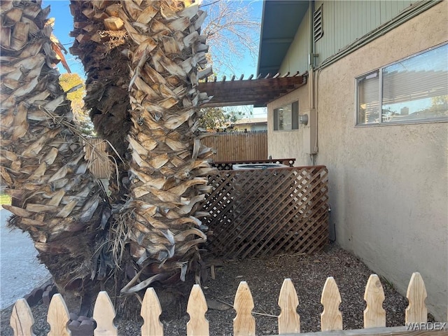 exterior details with fence and stucco siding