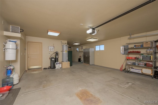 garage featuring strapped water heater and a garage door opener