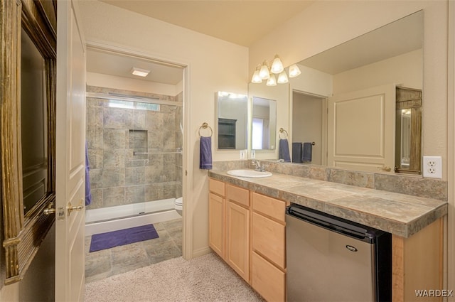 bathroom featuring a stall shower, vanity, and toilet