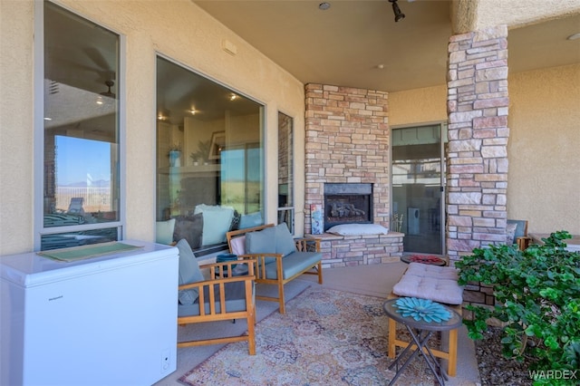 view of patio / terrace with an outdoor stone fireplace