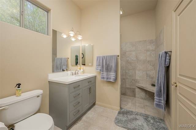 full bathroom with toilet, an inviting chandelier, and vanity