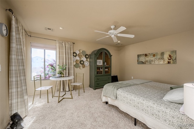 carpeted bedroom with ceiling fan and visible vents