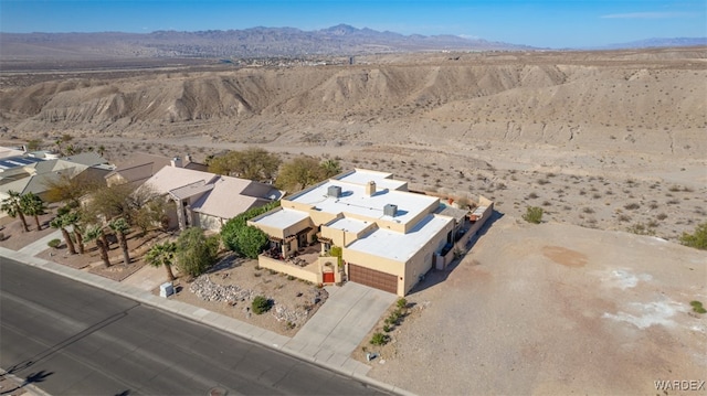 birds eye view of property with a desert view and a mountain view