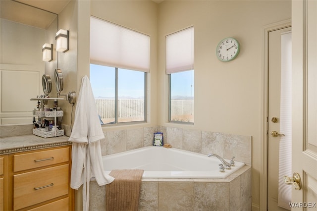 full bath featuring a bath and vanity