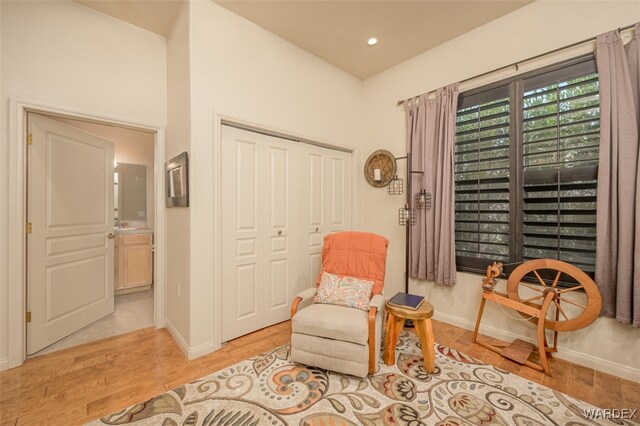 sitting room featuring recessed lighting, baseboards, and light wood finished floors