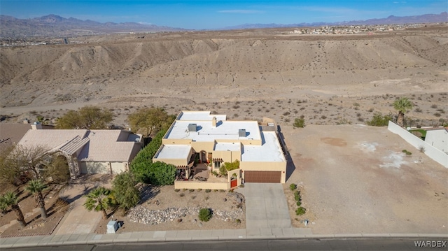 birds eye view of property featuring a desert view and a mountain view