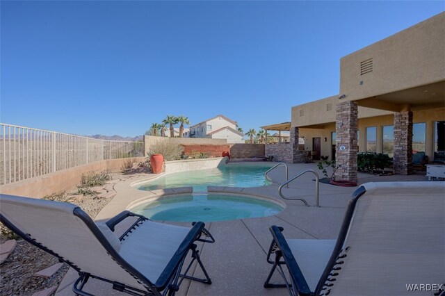 view of pool with a fenced backyard, a patio, and an in ground hot tub