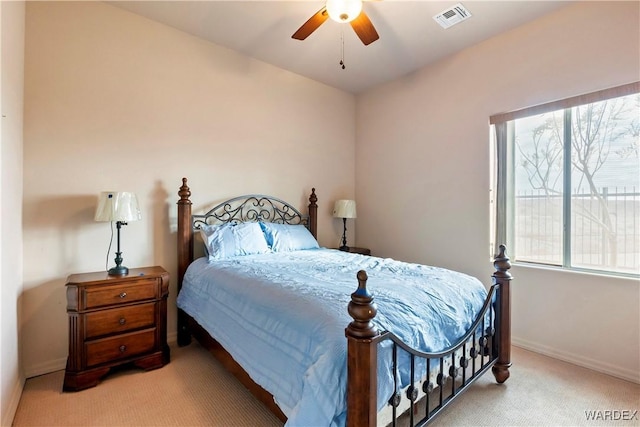 bedroom with light colored carpet, visible vents, baseboards, and multiple windows