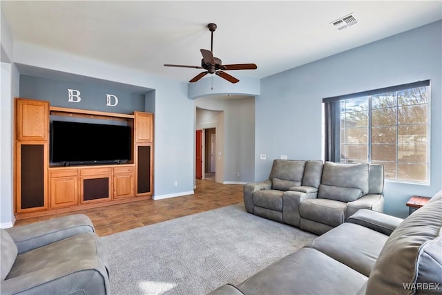 living area featuring ceiling fan, light carpet, visible vents, and baseboards