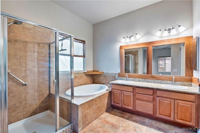 bathroom featuring a stall shower, a sink, and a bath