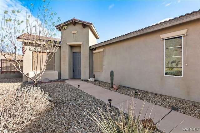 view of front of home with fence and stucco siding