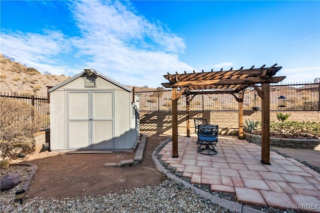 view of shed featuring a fenced backyard and a pergola