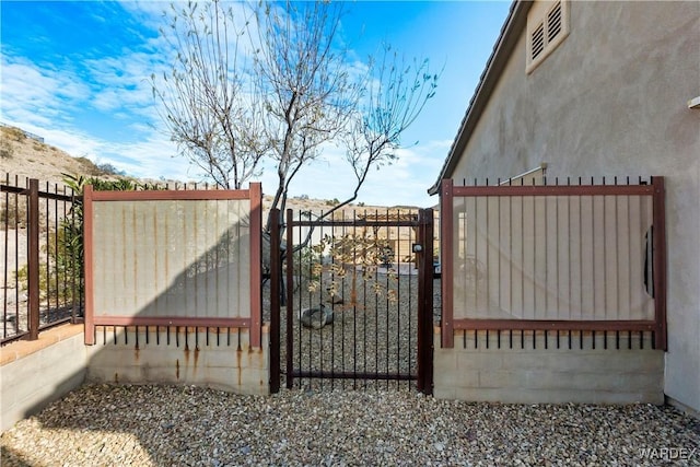 view of gate with fence