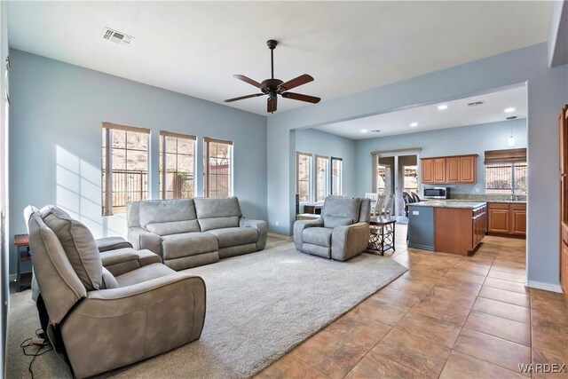 living area with ceiling fan, light tile patterned floors, recessed lighting, visible vents, and baseboards