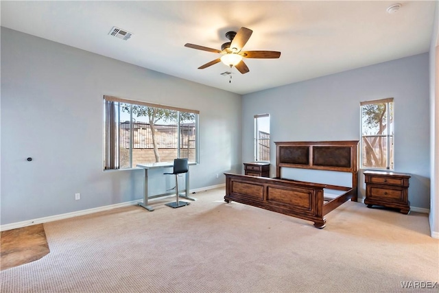 bedroom featuring light carpet, a ceiling fan, visible vents, and baseboards