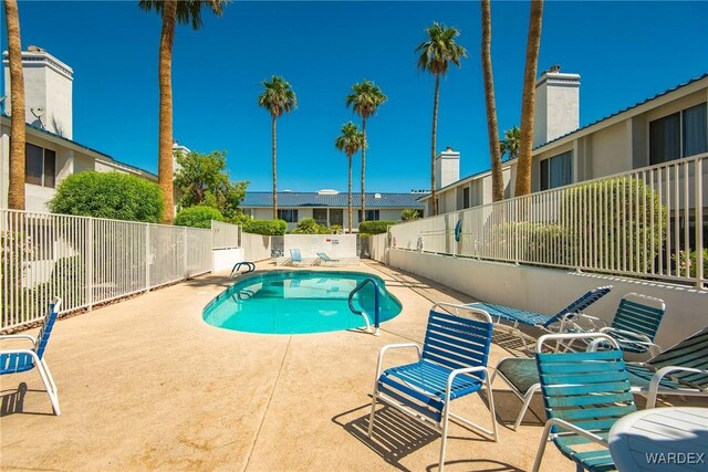 pool featuring a patio area and fence