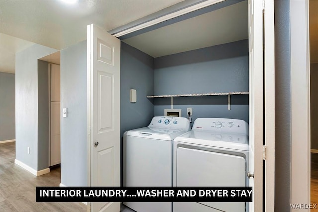 washroom featuring baseboards, laundry area, wood finished floors, and washer and dryer