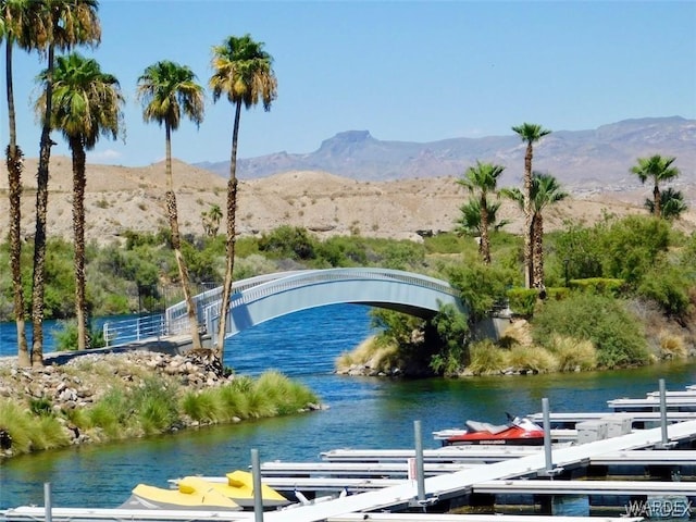 view of water feature with a boat dock and a mountain view