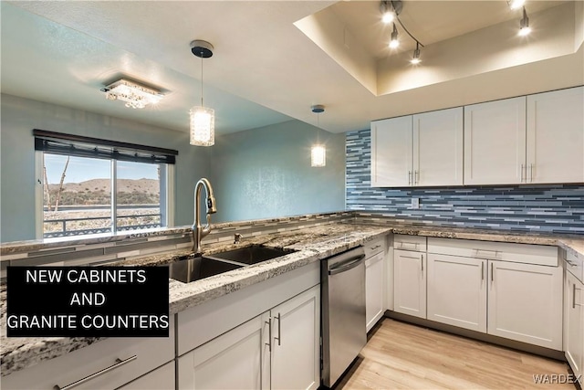 kitchen with tasteful backsplash, light wood-type flooring, dishwasher, and a sink