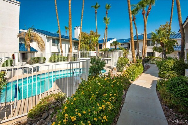 pool with fence and a residential view