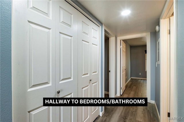 hallway with wood finished floors and baseboards