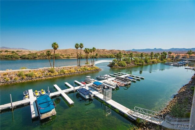 view of dock with a water and mountain view