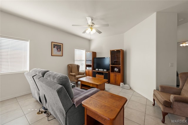 living area with ceiling fan, light tile patterned flooring, and baseboards