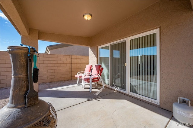 view of patio / terrace featuring fence