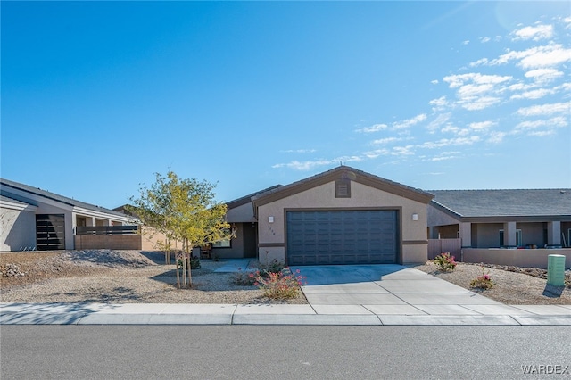 mid-century inspired home featuring driveway, an attached garage, and stucco siding